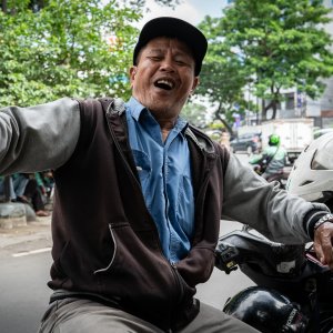 Motorbike taxi driver waiting for customers at an intersection
