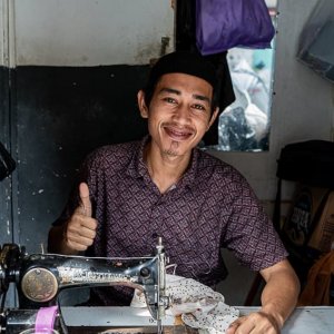 Young tailor working with an old sewing machine