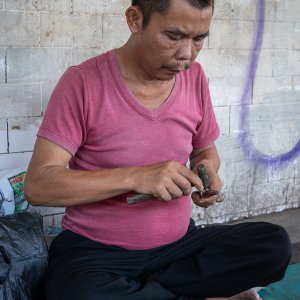Man selling rings on the sidewalk