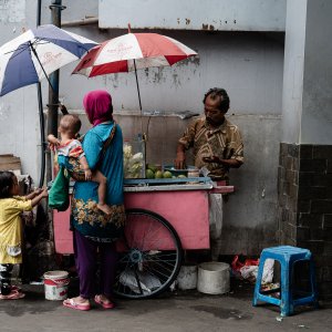 Parent and children shopping at a fruit stall