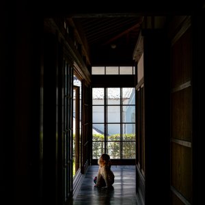 Girl relaxing on the porch of an old house