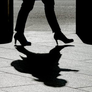 Silhouette walking briskly in high heels