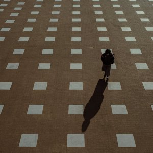 Woman walking while stepping on a square drawn on the ground
