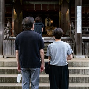 People praying at Okusawa Jinja Shrine