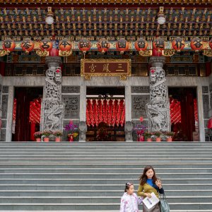 Mother and daughter descending the steps of Sanfong Temple