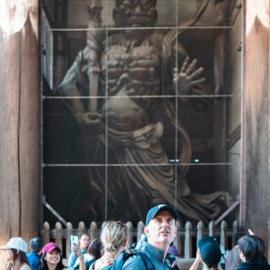 Man looking at the statue of Vajrayaksa at Nandai-mon