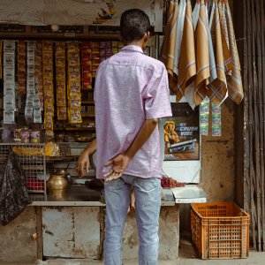 Back view of a man shopping at a kiosk