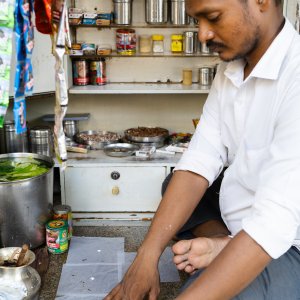 Man selling paan at a kiosk