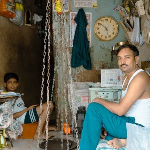 Father and son relaxing in a store with a large balance