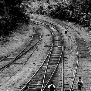 school boys walking on railway track