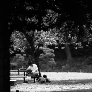 Parent and children relaxing in park