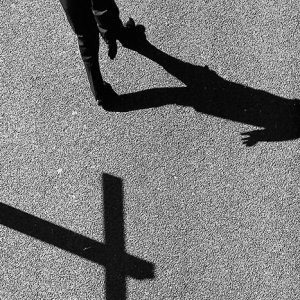 Shadow of cross on ground