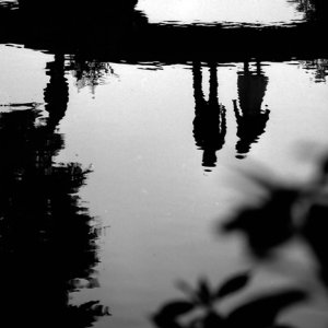 Figures reflected on pond