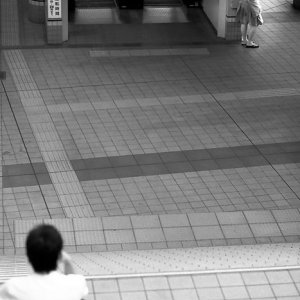 boy on stairway and woman beside escalator