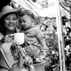 Mother holding mug and baby