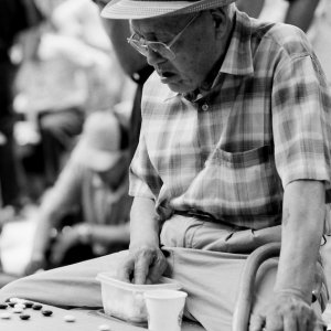Old man playing Go in park