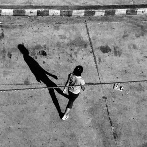Long shadow of crossing woman