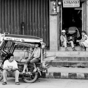 Local people relaxing by roadside