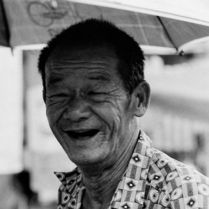 Wrinkled smile of trishaw driver