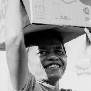 Woman carrying a cardboard box over her head