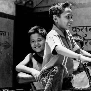 Boys playing around bicycle