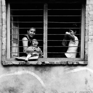 Mother and kids relaxing by window