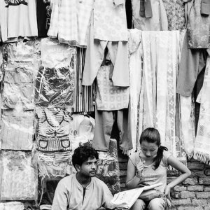 Man and woman selling clothes on street