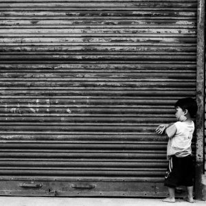 Boy playing in front of shutter