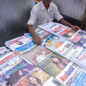 Young man selling magazines