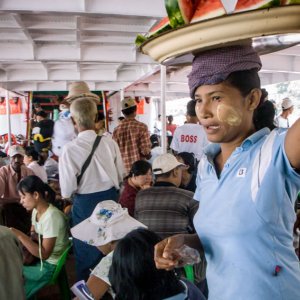 Woman selling watermelons on ferry