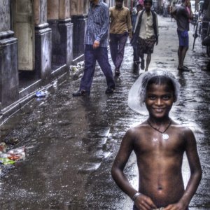Boy standing in rain