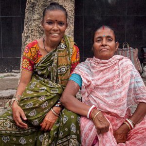 Two women wearing saree