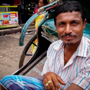 rickshaw wallah wearing striped shirt 