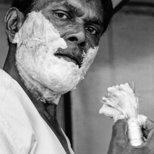 Man putting shaving cream on face