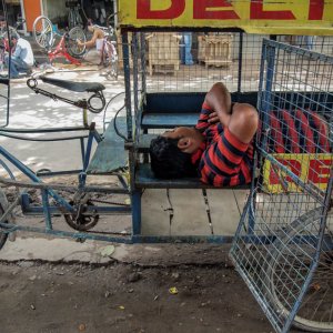Man sleeping in cage