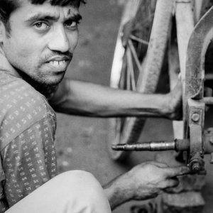 Man repairing cycle rickshaw