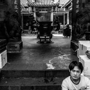 Man sitting at entrance of temple