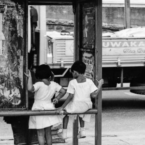 Little girls at bus stop