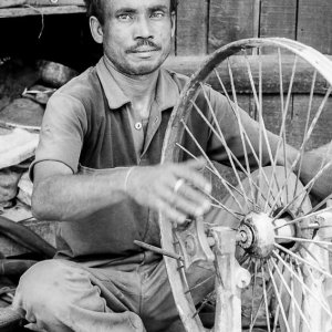 Man repairing cycle rickshaw