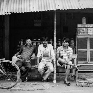 Men relaxing on bench in cafe