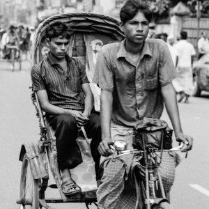 Rickshaw wallah pedaling cycle rickshaw