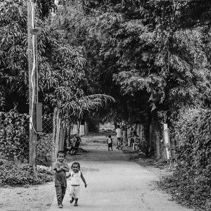 Little kids walking road