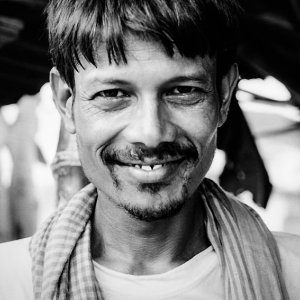 Man grinning a ghastly smile