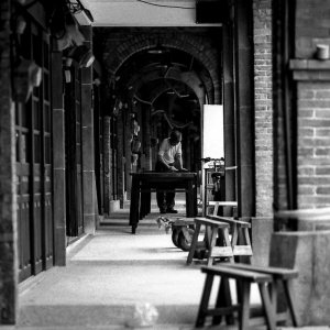 Man working in passage in Minchuan Old Street