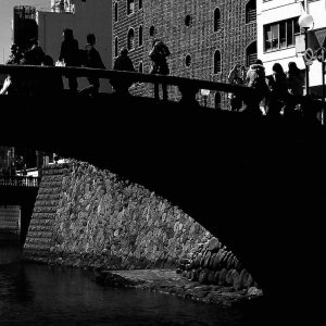 silhouettes on black bridge