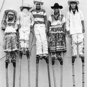 Boys wearing tall stilts