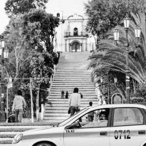 Cab parked at the bottom of the stairs leading to the church