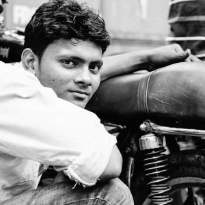 Young man beside motorbike