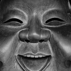 Wooden mask smiling
