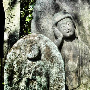 Stone statue relaxing in sunny spot
